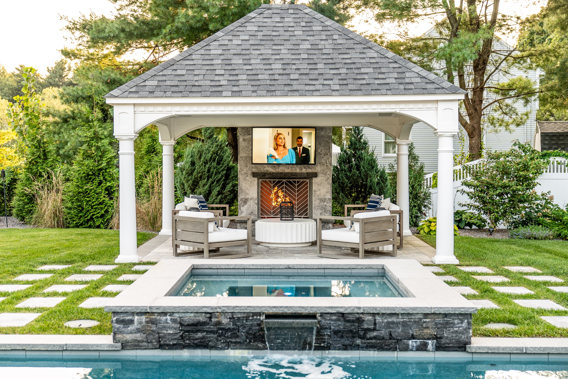 Poolside spa and Gazebo with fireplace and TV. Dex by Terra Landscape design / build project in Andover, Massachusetts.