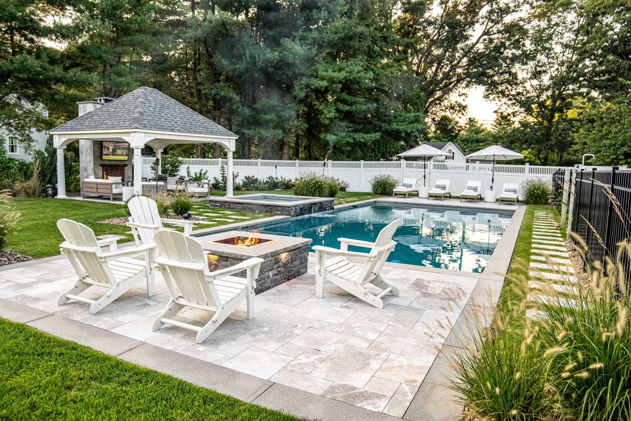 Poolside fire pit and stone paver patio with gazebo. Dex by Terra Landscape design / build project in Andover, Massachusetts.